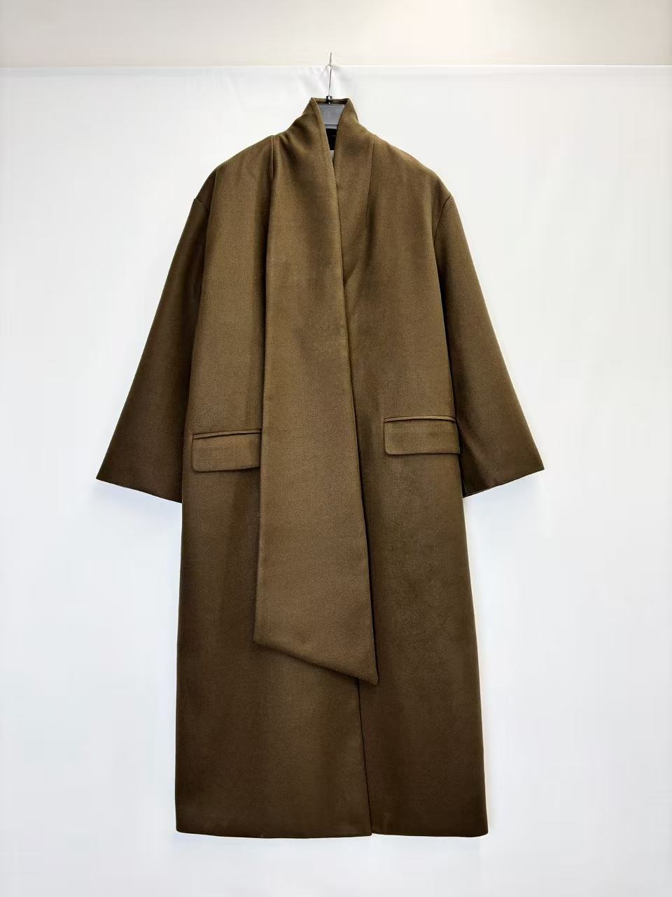 Coat with decorative scarf