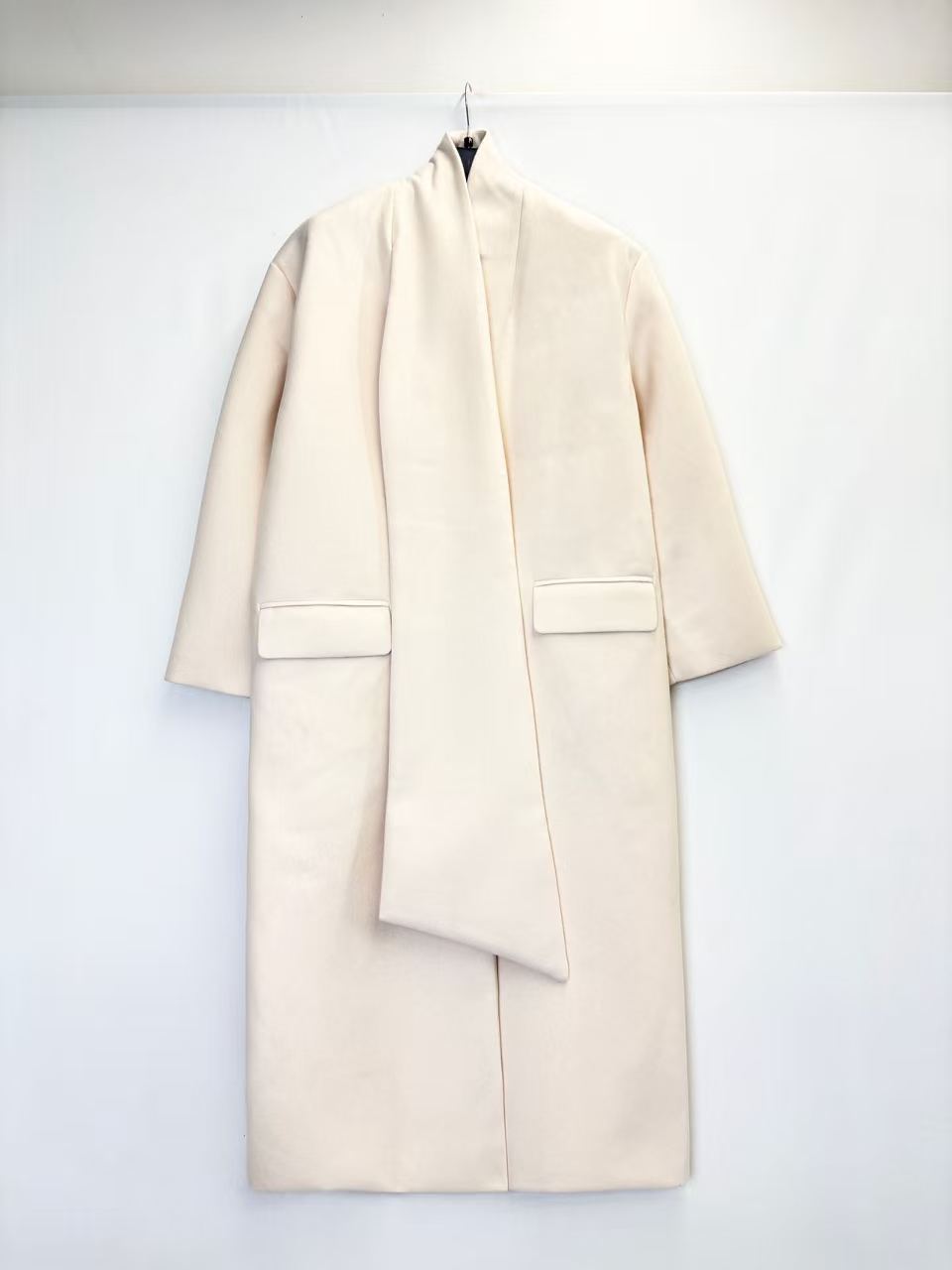 Coat with decorative scarf