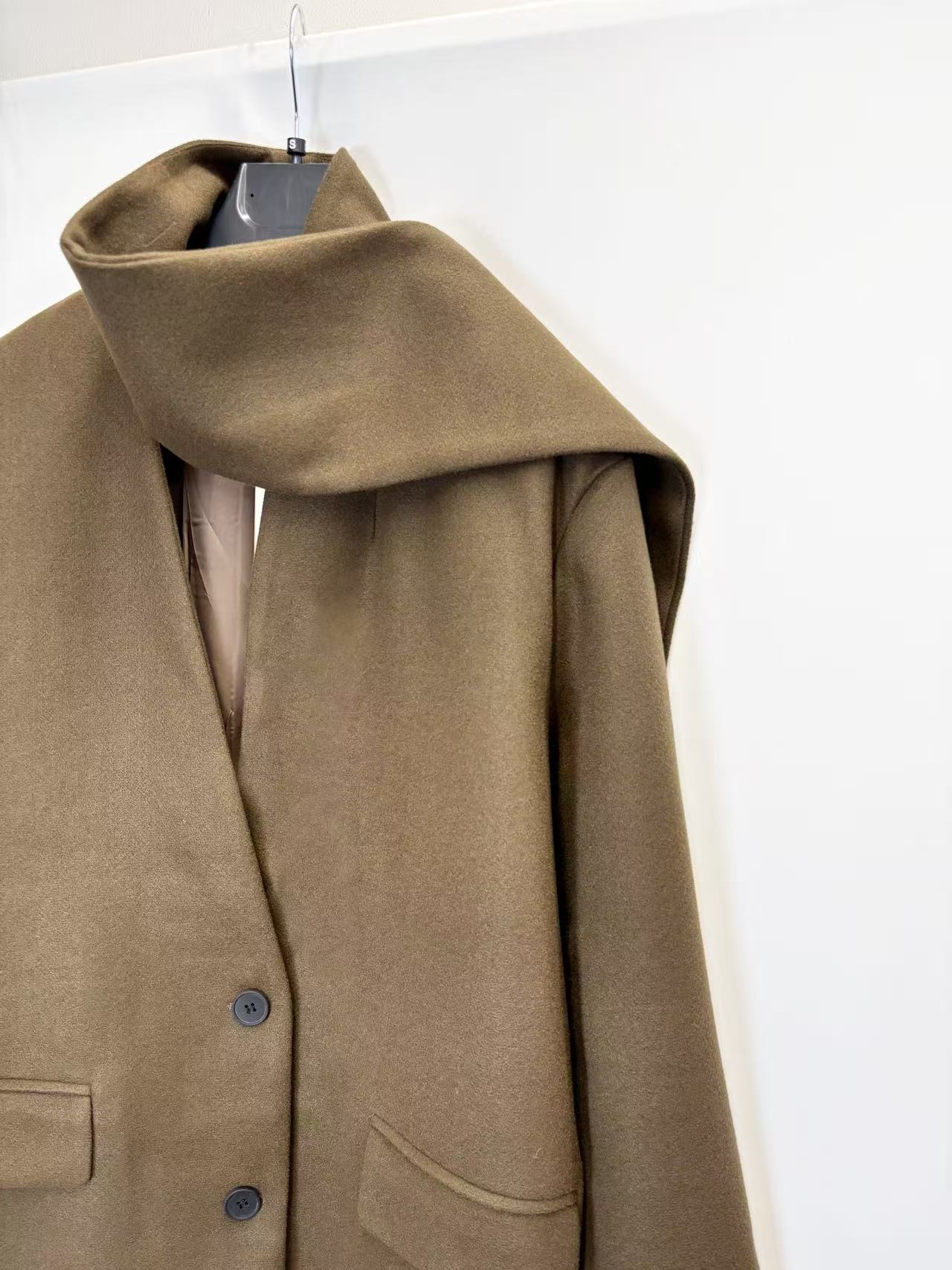 Coat with decorative scarf